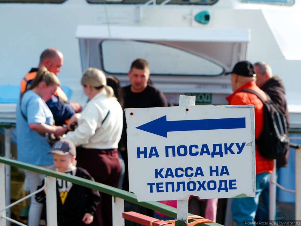 Касса на посадку рядом с речным теплоходом.